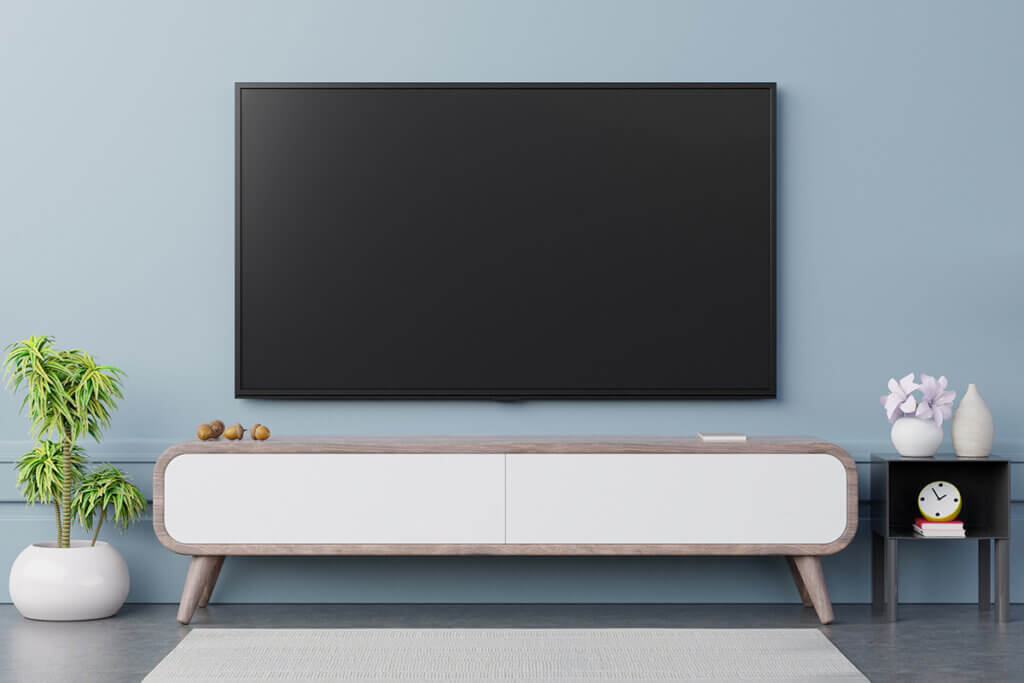 75 inch tv hangs on blue wall
