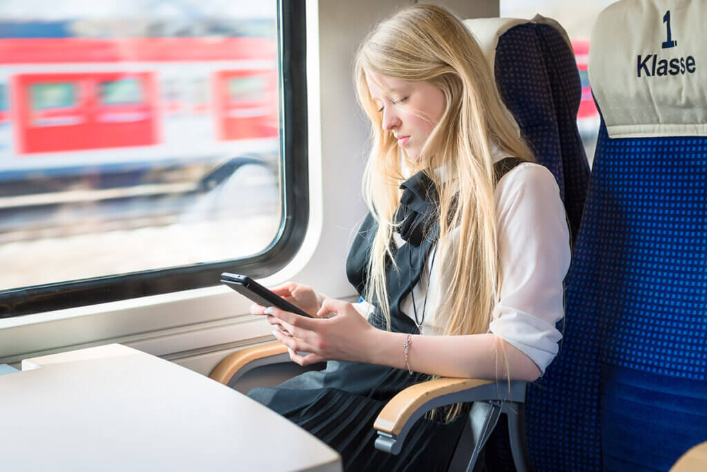 Girl on the train with a tablet