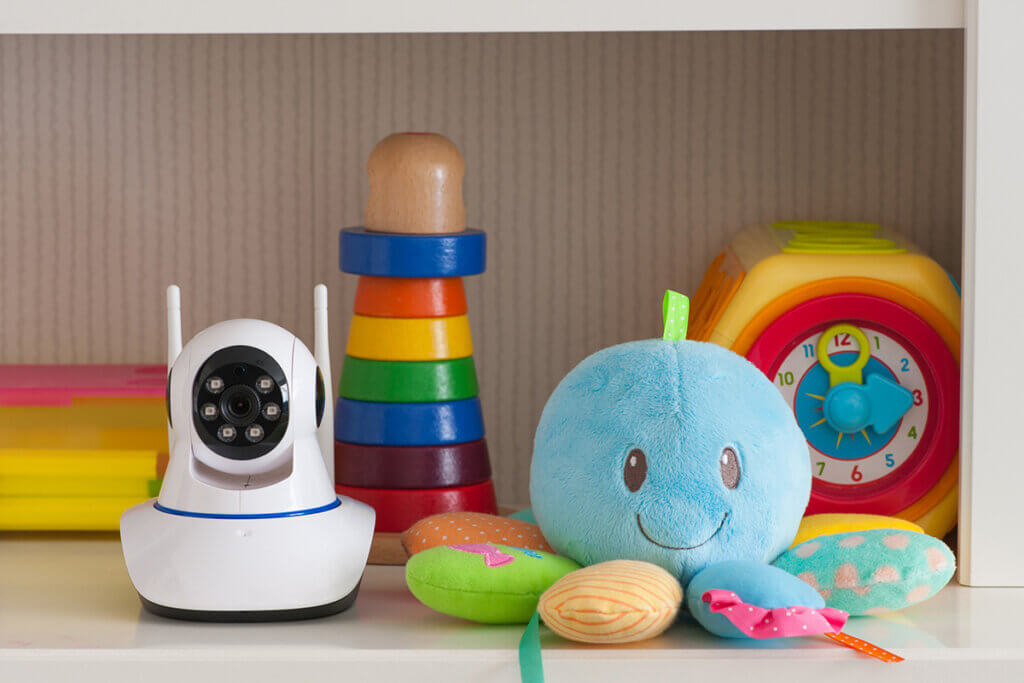 Babyphone camera on shelf with toys