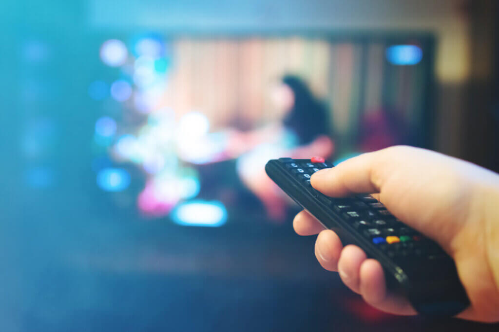 blu ray player person shows remote control on tvv