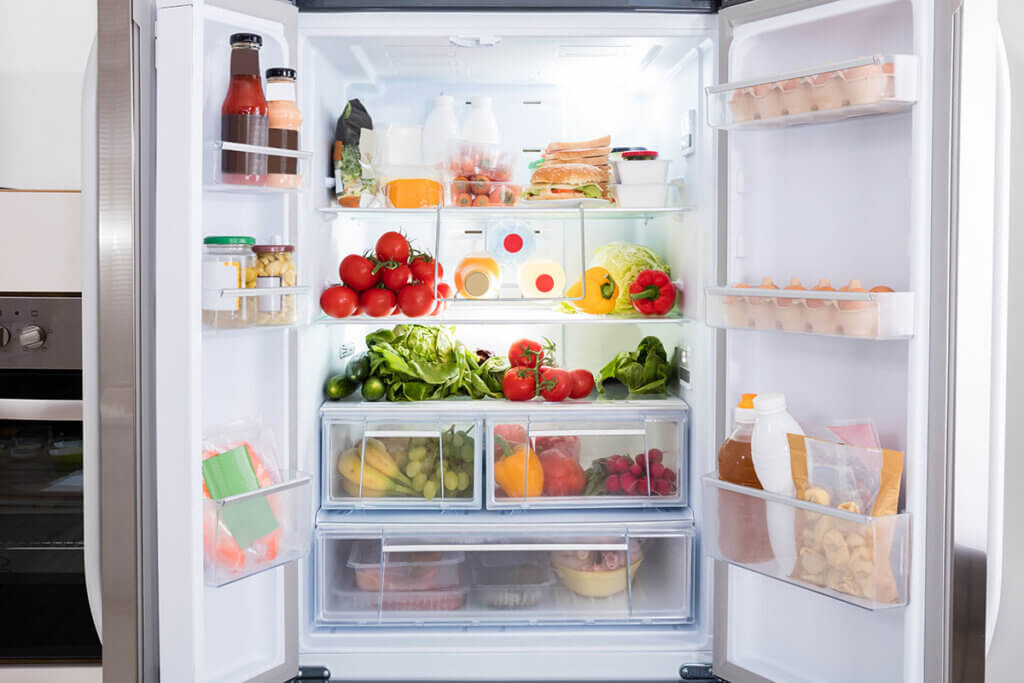 View into a filled built-in refrigerator