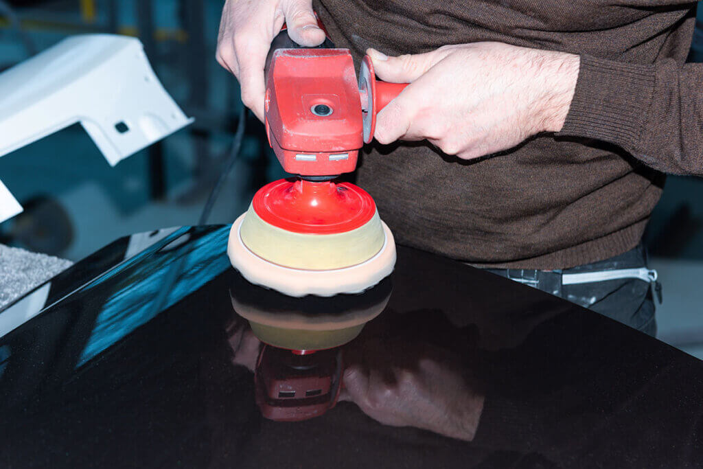 A car part is polished with a polishing machine