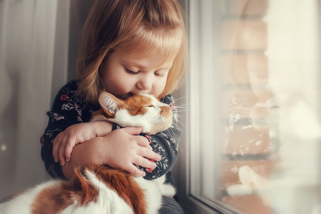 small girl holding cat