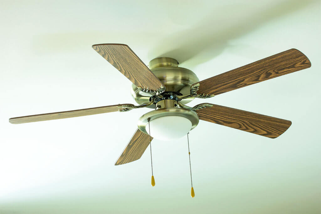 Wooden fan hangs from the ceiling