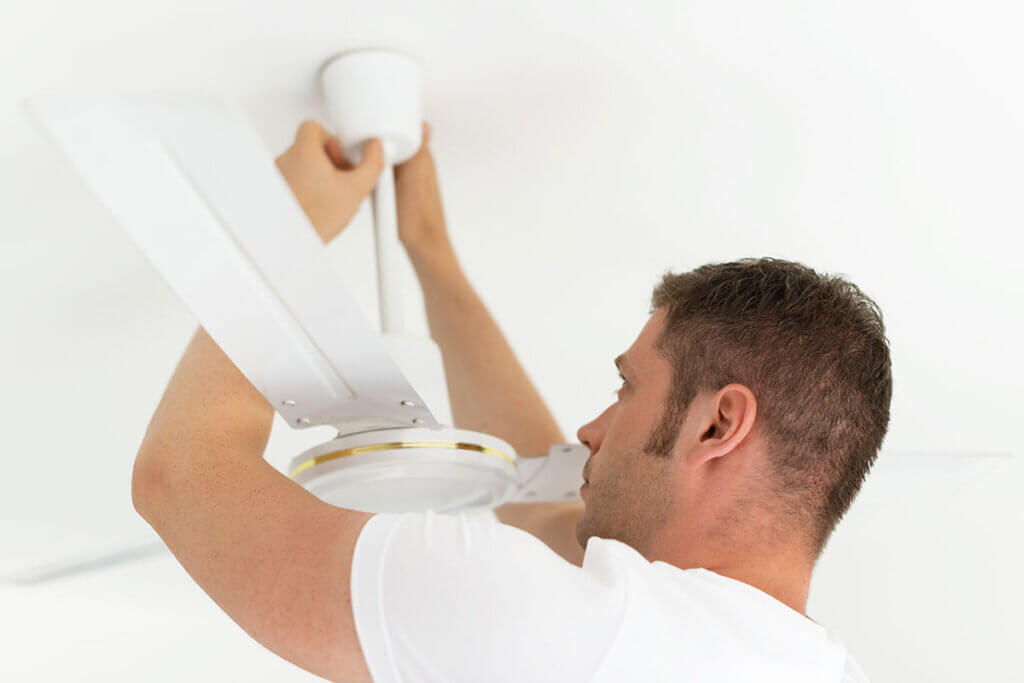 Man installs ceiling fan