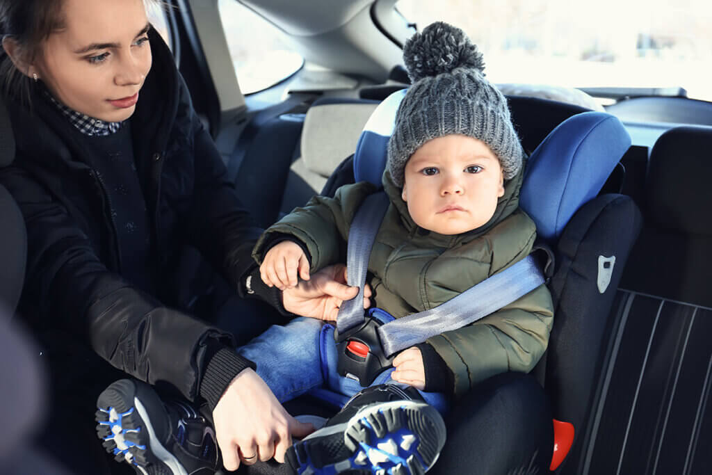 baby looks into camera when strapping in