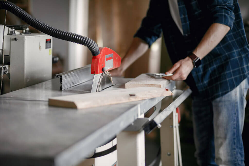 Person cuts wood with circular saw