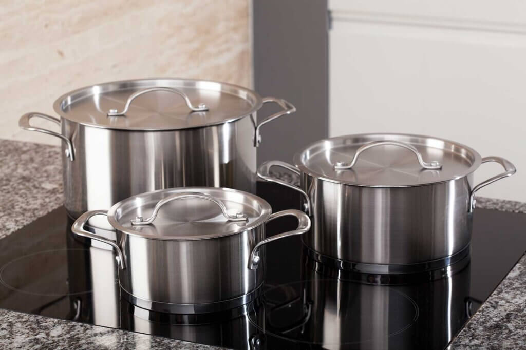 Three pots standing on cooker in kitchen
