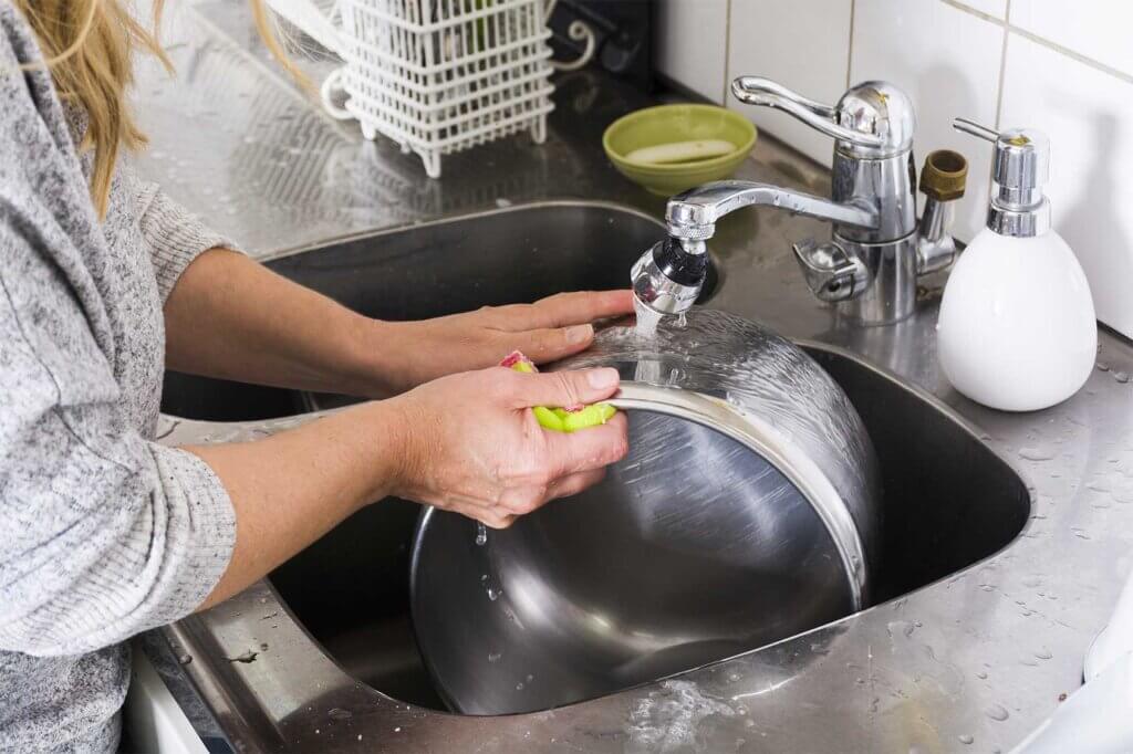 Woman rinsing pot