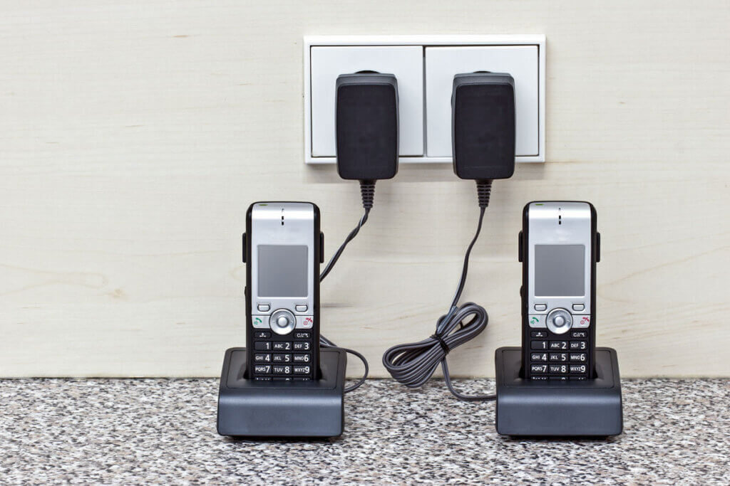 two cordless phones in her base