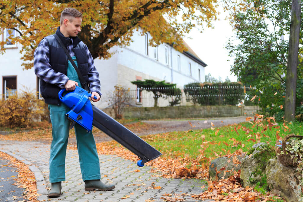 Man blowing pavement