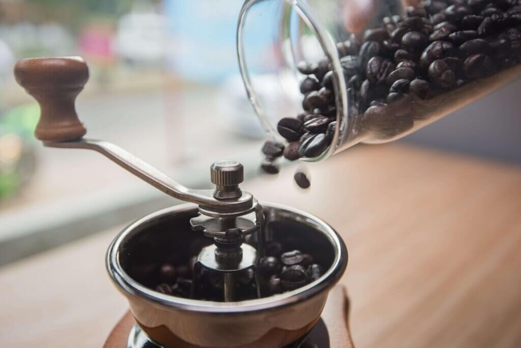 espresso beans in coffee grinder