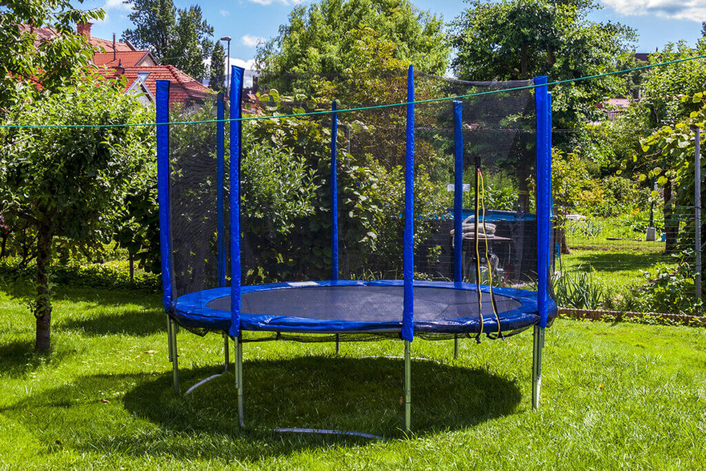 Large blue trampoline in the garden