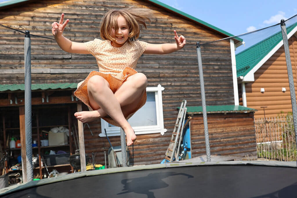 Children jumping on the garden trampoline
