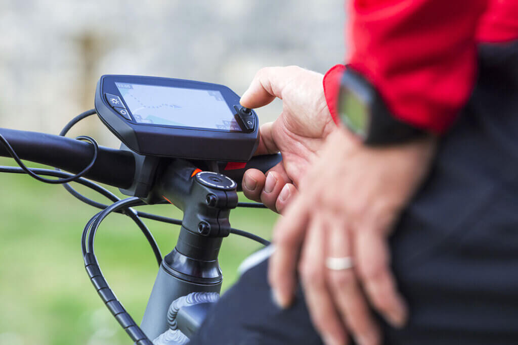 navigation device close up of navi on handlebars with cyclist