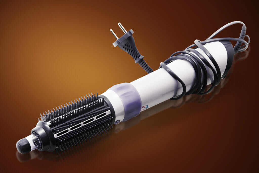 Hair dryer brush with coiled cable