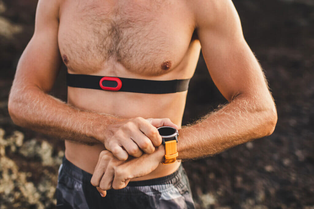 Torso-free man with heart rate monitor and chest strap