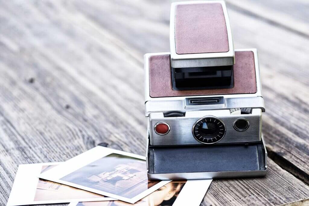 old instant camera with photos next door
