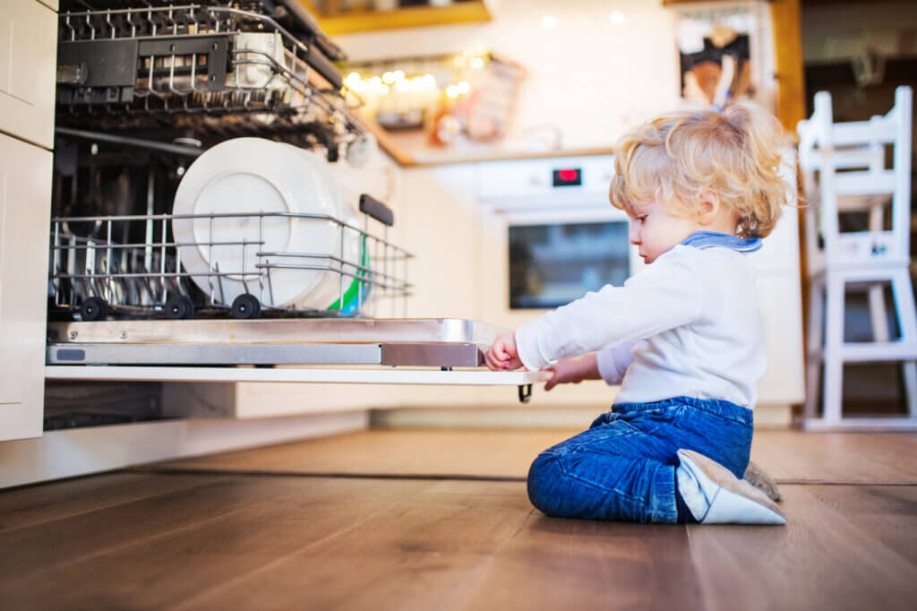 Toddler in front of dishwasher