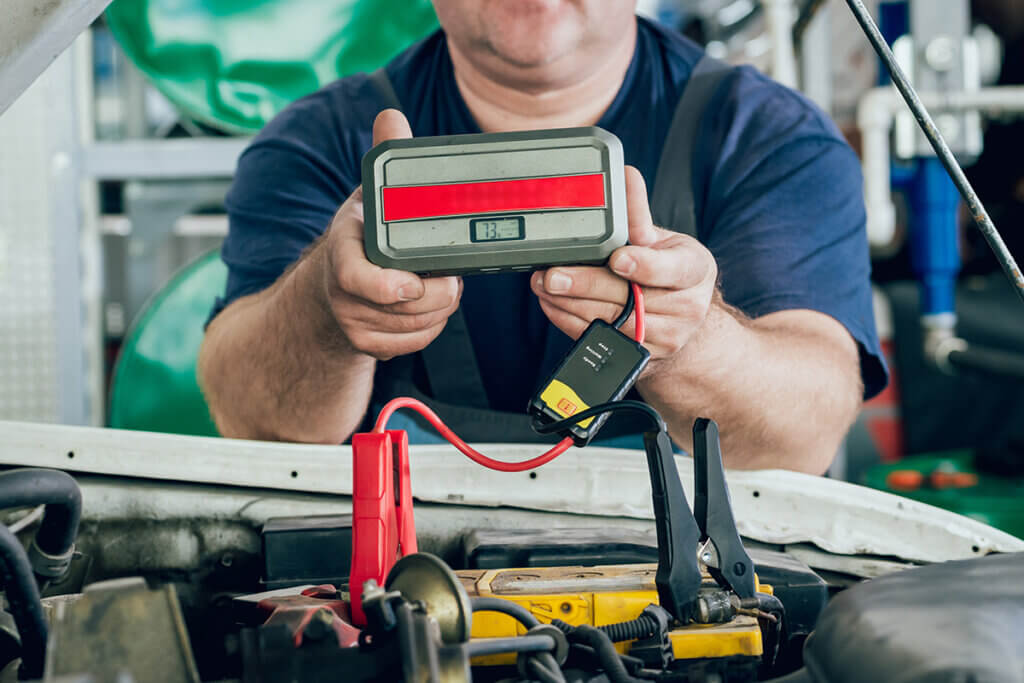 Man holding jump starter in his hands
