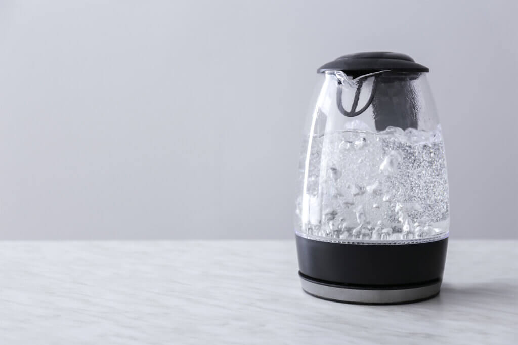 transparent kettle with boiling water