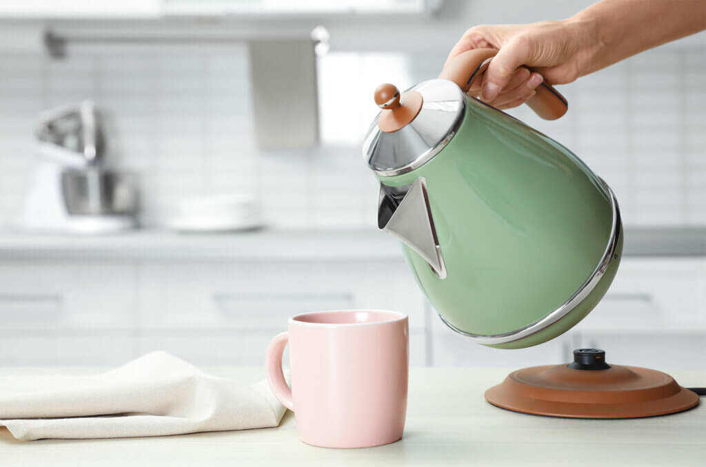 kettle woman pours hot water in a cup