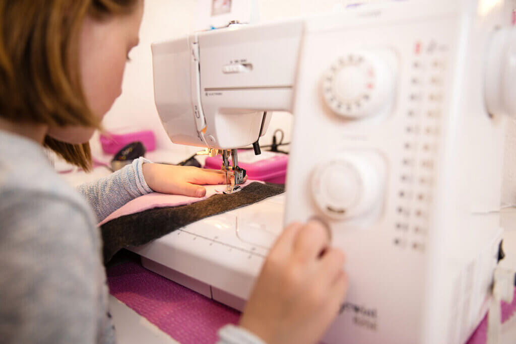 Child sewing a garment
