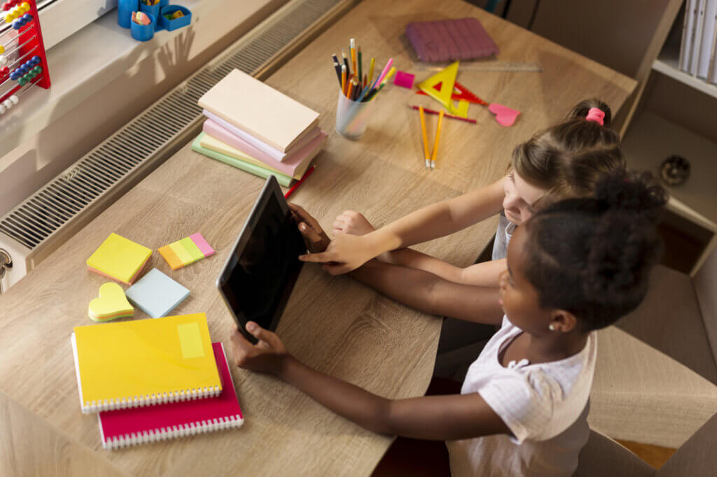 Two girls playing with a tablet