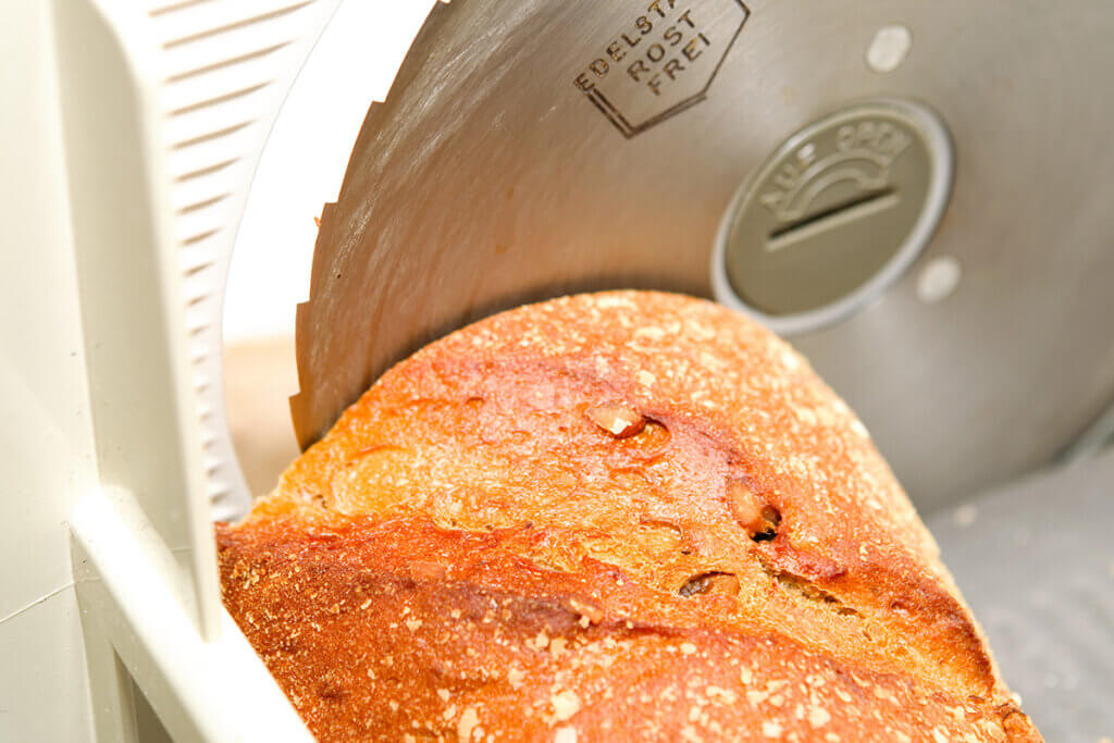Close-up of a bread slicer with bread