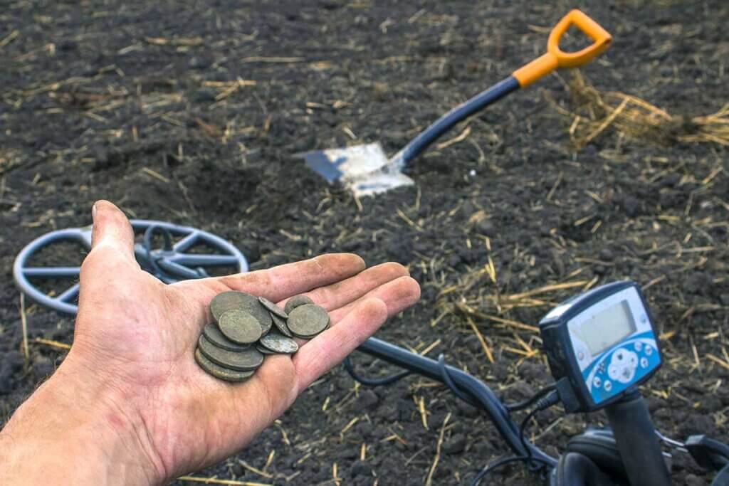 Man holds dirty coins in hand