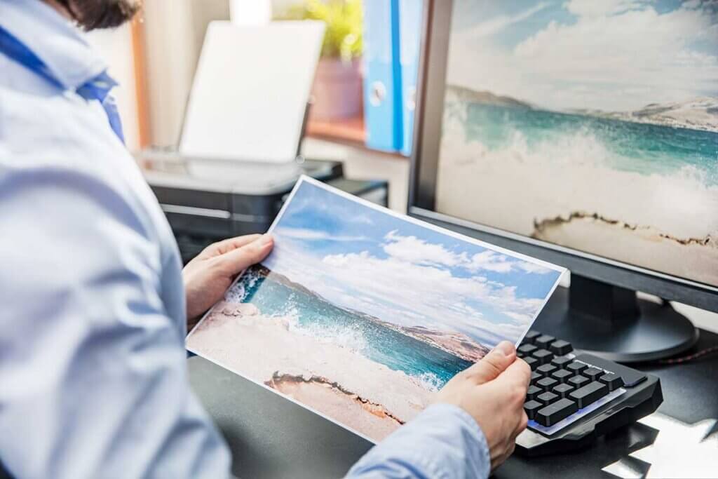 Man looking at printed picture