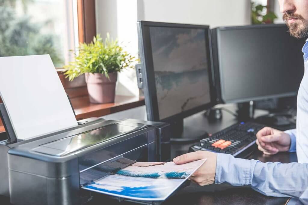 Man takes picture from printer