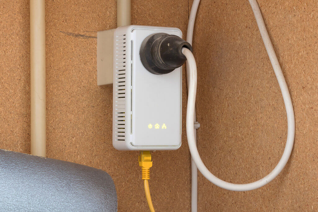powerline adapter in the shed in a socket that is installed on a chipboard.