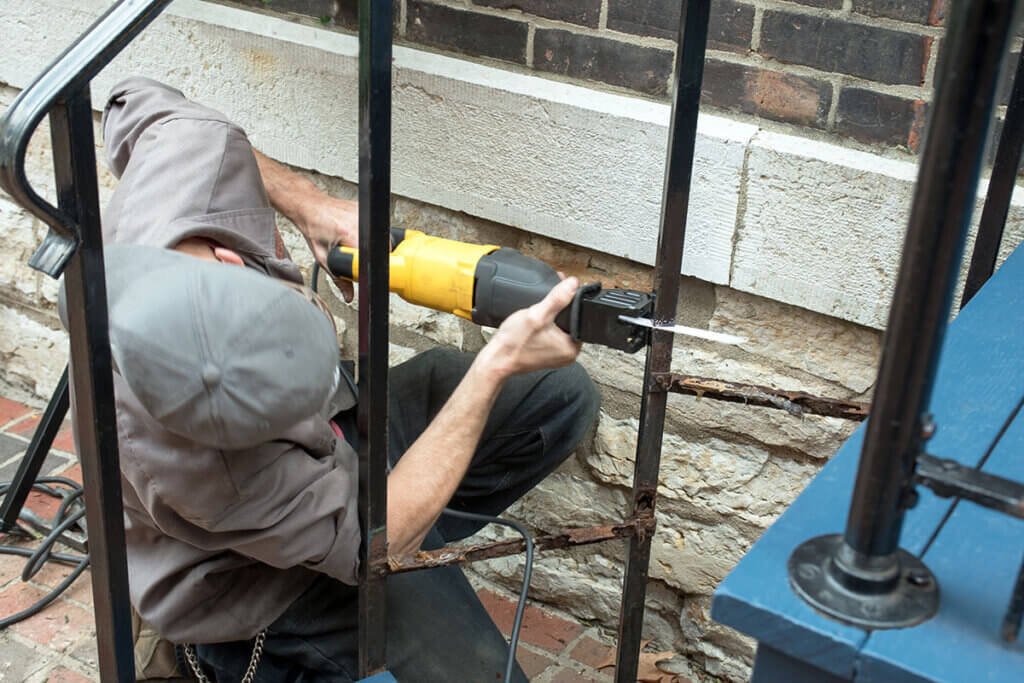 person using reciprocating saw