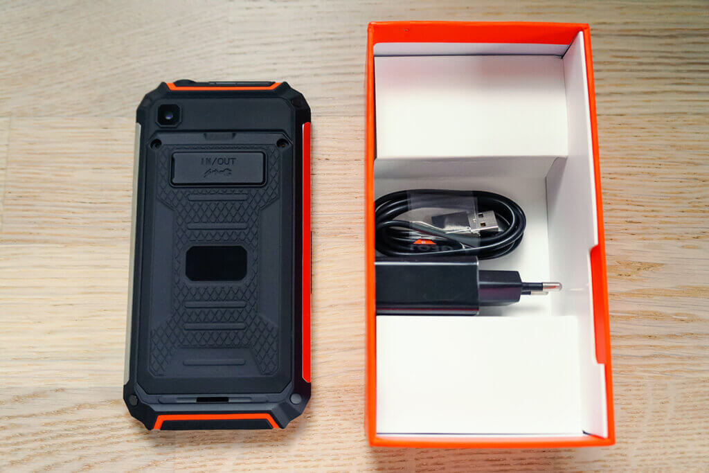 Unpacked smartphone next to packaging