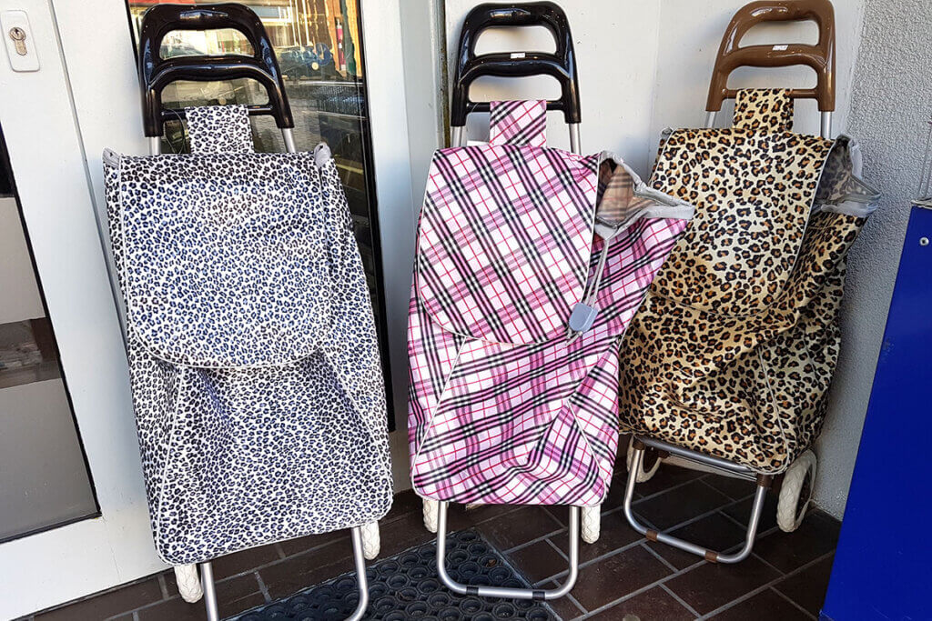 Three differently patterned shopping trolleys next to each other