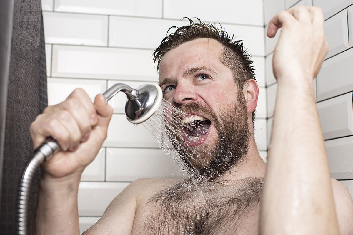 man sings in shower