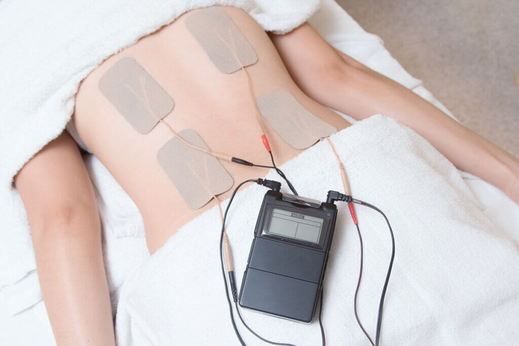 TENS unit and electrodes attached to the back