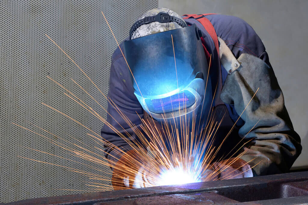 Person welding steel beams