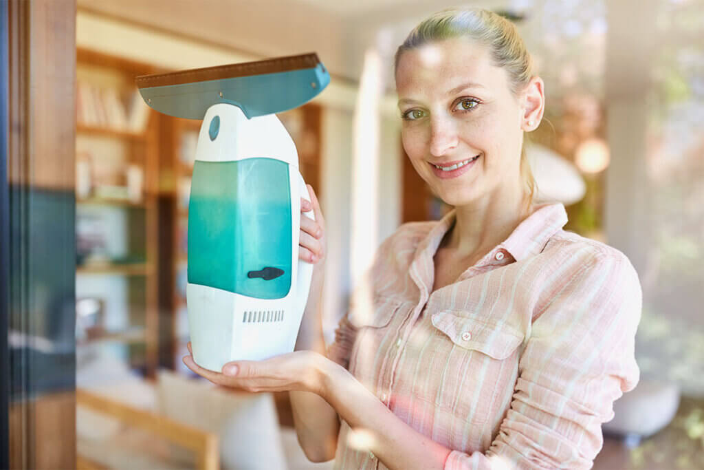 Woman holding electric window cleaner