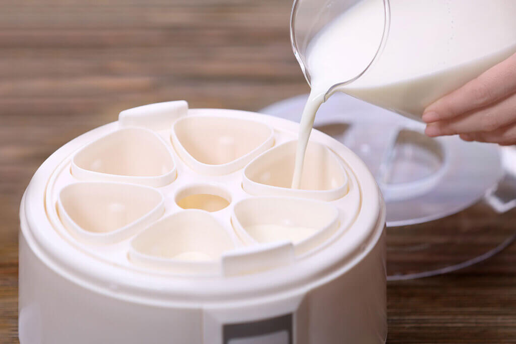 milk being poured into maker